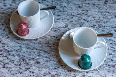 two cups and saucers with candles on a table at iFlat Colosseum & Monti Cozy Bright Dream in Rome