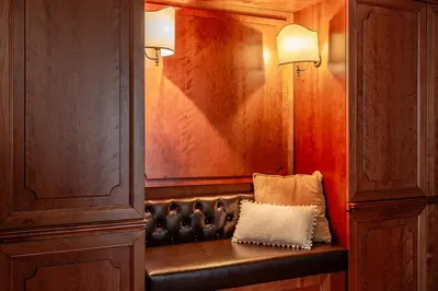 a leather bench with a pillow on it in a room at iFlat Colosseum & Monti Cozy Bright Dream in Rome