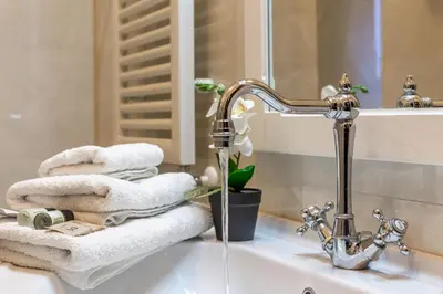 a bathroom sink with towels and a faucet at iFlat Colosseum & Monti Cozy Bright Dream in Rome
