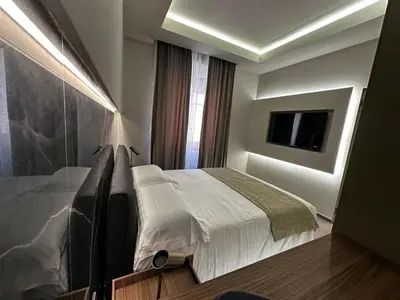 a bedroom with a bed and a flat screen tv at Roma Suite Major in Rome