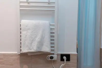 a bathroom with a white towel on a rack at Il Melograno - Casa Palmeri in Rome