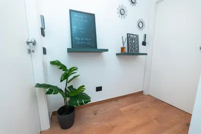 a plant in a hallway with a chalkboard on the wall at Il Melograno - Casa Palmeri in Rome
