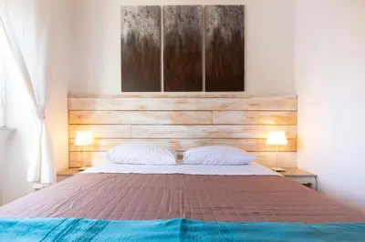 a bedroom with a large bed with two pillows at Sunny Charming 3 BDR, 3BATH Home in Rome