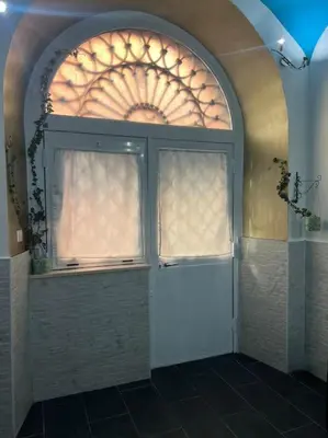 a white door with a window in a bathroom at Fenty Home 2 San Lorenzo in Rome