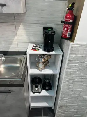 a kitchen with a sink and a shelf with a coffee maker at Fenty Home 2 San Lorenzo in Rome