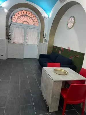 a living room with a couch and a table at Fenty Home 2 San Lorenzo in Rome