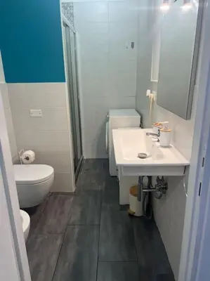 a bathroom with a toilet and a sink and a shower at Fenty Home 2 San Lorenzo in Rome