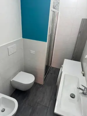 a bathroom with a toilet and a sink and a shower at Fenty Home 2 San Lorenzo in Rome