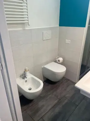 a small bathroom with a toilet and a sink at Fenty Home 2 San Lorenzo in Rome