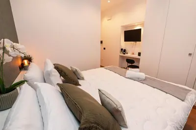 a bedroom with a large white bed with pillows at Il Mandorlo - Casa Palmeri in Rome