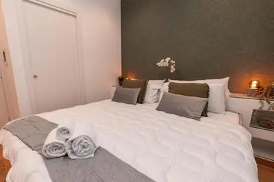 a bedroom with a large white bed with towels on it at Il Mandorlo - Casa Palmeri in Rome