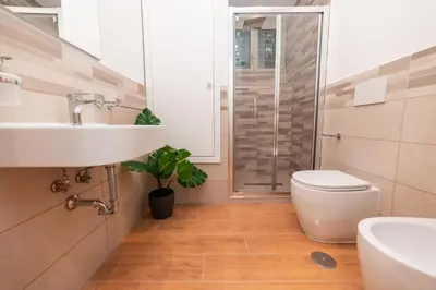 a bathroom with a toilet and a sink and a shower at Il Mandorlo - Casa Palmeri in Rome