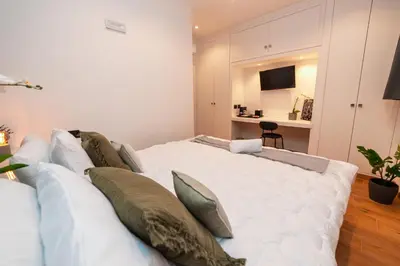a bedroom with a large white bed with pillows at Il Mandorlo - Casa Palmeri in Rome