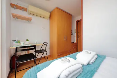 a bedroom with a bed and a desk and a table at Magic Trastevere suite on roof terrace in Rome