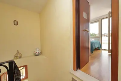 a hallway with a door leading to a bedroom at Magic Trastevere suite on roof terrace in Rome