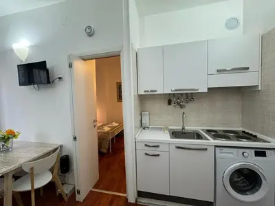 a kitchen with a sink and a washing machine at San Giovanni's Cozy Apartment in Rome