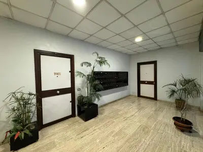 an empty room with two doors and plants in it at San Giovanni's Cozy Apartment in Rome