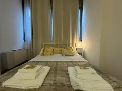 a bedroom with a bed with two towels on it at San Giovanni's Cozy Apartment in Rome