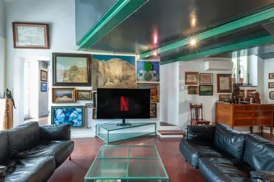 a living room with leather couches and a flat screen tv at Elegantis Dimora dell'Architetto in Campo de' Fiori With private terrace in Rome