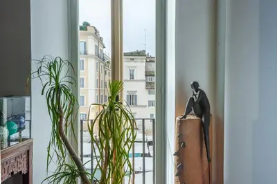 a statue of a man sitting on top of a window at Elegantis Dimora dell'Architetto in Campo de' Fiori With private terrace in Rome