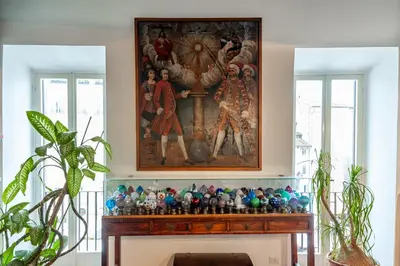 a painting above a fireplace in a living room at Elegantis Dimora dell'Architetto in Campo de' Fiori With private terrace in Rome