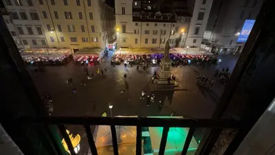 a crowd of people walking around a street at night at Elegantis Dimora dell'Architetto in Campo de' Fiori With private terrace in Rome