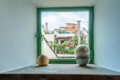 an open window with a view of a city at Elegantis Dimora dell'Architetto in Campo de' Fiori With private terrace in Rome