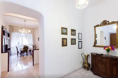 a living room with a mirror and a dining room at Caterina One o One - Embassy Apartment in Rome