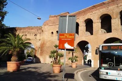 a bus is parked in front of a building at Caterina One o One - Embassy Apartment in Rome