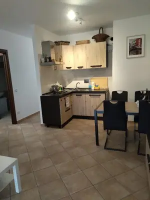 a kitchen with a table and a table and chairs at La Casa Vicino a Tutto in Rome