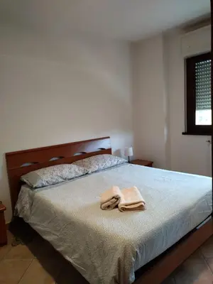 a bedroom with a bed with two towels on it at La Casa Vicino a Tutto in Rome