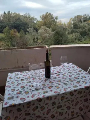 a bottle of wine sitting on a table on a balcony at La Casa Vicino a Tutto in Rome