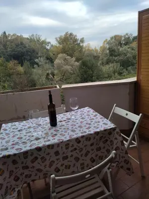 a bottle of wine sitting on a table on a balcony at La Casa Vicino a Tutto in Rome