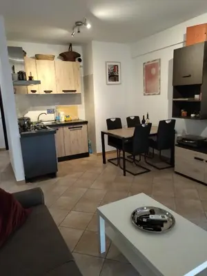 a kitchen and a living room with a table and a living room at La Casa Vicino a Tutto in Rome