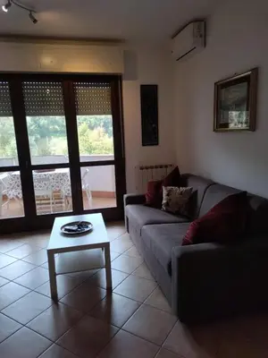 a living room with a couch and a coffee table at La Casa Vicino a Tutto in Rome