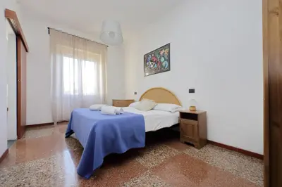 a bedroom with a bed with a blue blanket at Silvano's Home In Rome in Rome