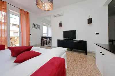 a bedroom with a large white bed with red pillows at Silvano's Home In Rome in Rome