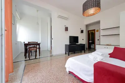a bedroom with a bed and a desk and a television at Silvano's Home In Rome in Rome