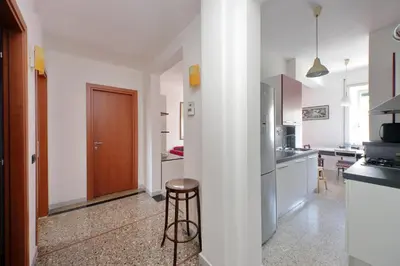 a kitchen with a stool in the middle of a room at Silvano's Home In Rome in Rome