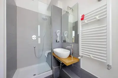 a white bathroom with a sink and a shower at Silvano's Home In Rome in Rome