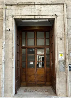 a large wooden door of a building at Cozy House Roma - San Giovanni in Rome