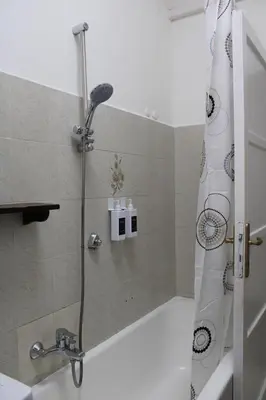 a shower in a bathroom with a shower curtain at Cozy House Roma - San Giovanni in Rome