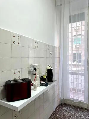 a kitchen with a toaster sitting on a shelf at Cozy House Roma - San Giovanni in Rome