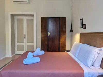 a bedroom with a large bed with two stuffed animals on it at Peaceful Roman Retreat in Rome