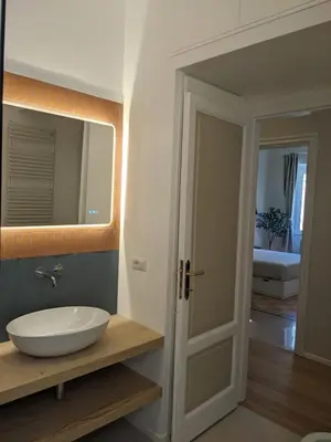 a bathroom with a sink and a mirror at Peaceful Roman Retreat in Rome