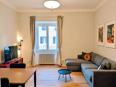 a living room with a couch and a table at Peaceful Roman Retreat in Rome