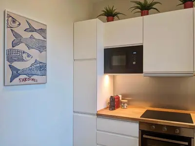 a kitchen with white cabinets and a microwave at Peaceful Roman Retreat in Rome