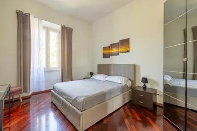 a bedroom with a large bed and a mirror at Attico vista San Pietro, vicino ai Musei Vaticani in Rome