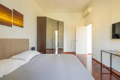 a bedroom with a large white bed in a room at Attico vista San Pietro, vicino ai Musei Vaticani in Rome
