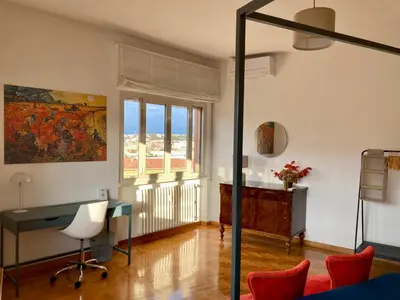 a living room with a desk and a window at Spazioso Appartamento Vicino al Vaticano in Rome